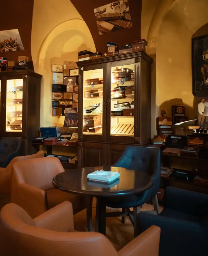 Vaulted cigar lounge with armchairs and humidor cabinets